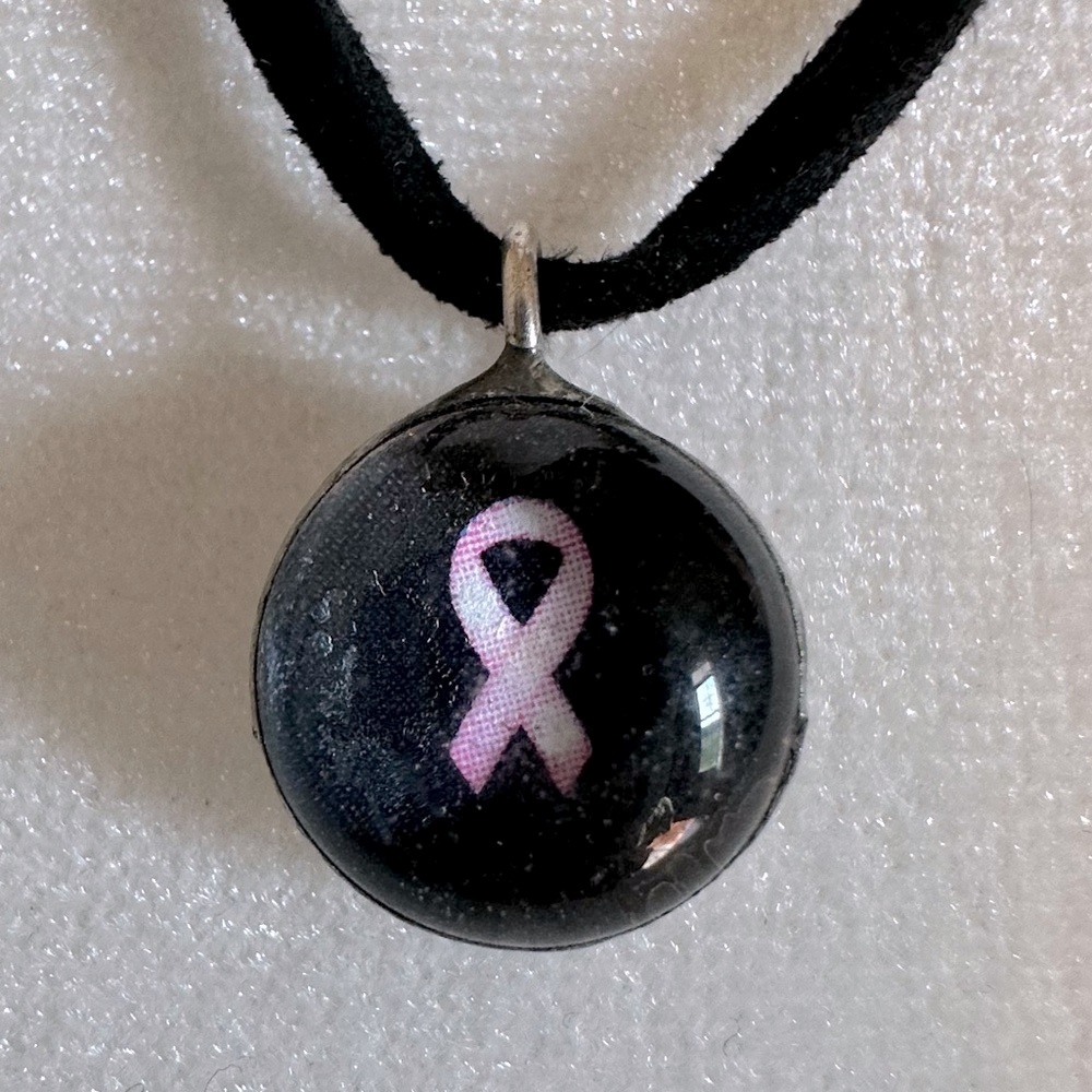 Women’s black leather breast cancer awareness necklace. Clear glass meddallion.